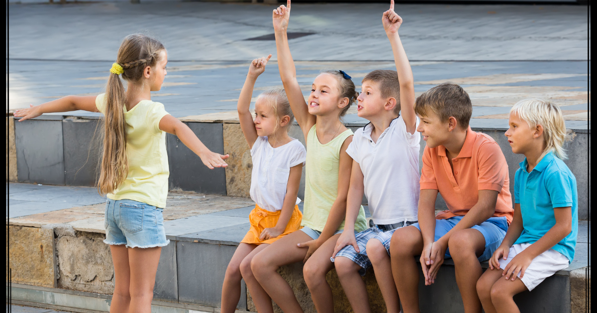 Students using charades to practice vocabulary in a language classroom